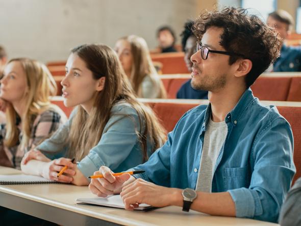 Students listen in a lecture hall