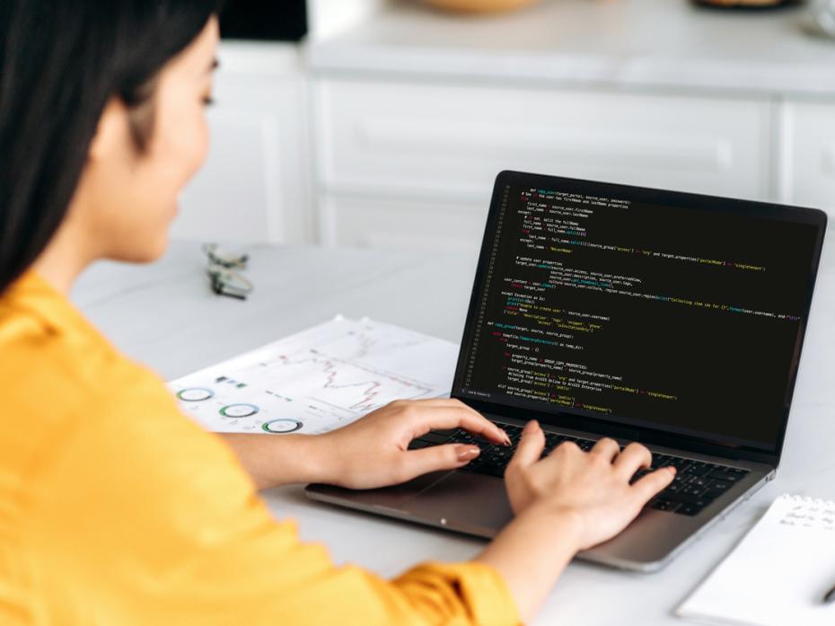 A computer programming student working on her laptop