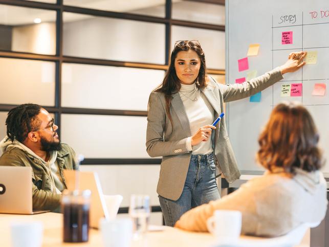 A team works on a project using a whiteboard