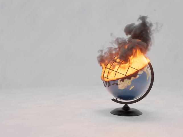 A globe on fire, belching smoke