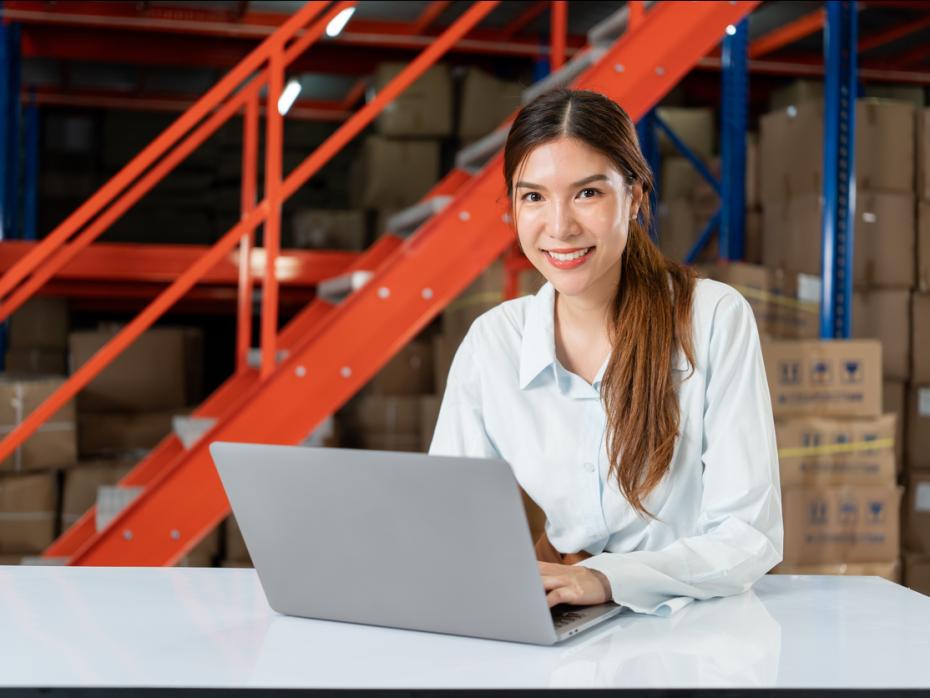 A logistics student working at her laptop