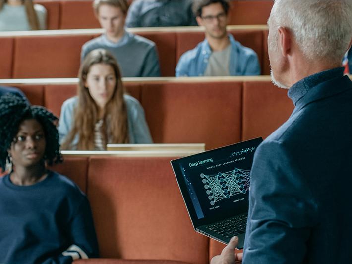 University professor teaching with laptop