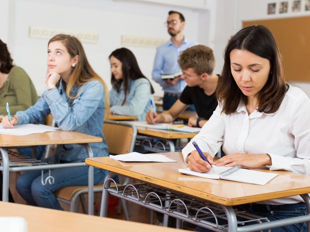 Students sit an exam in a classroom