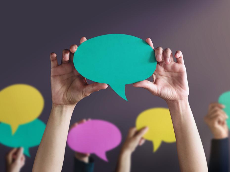 Speech bubbles being held above unseen person's head