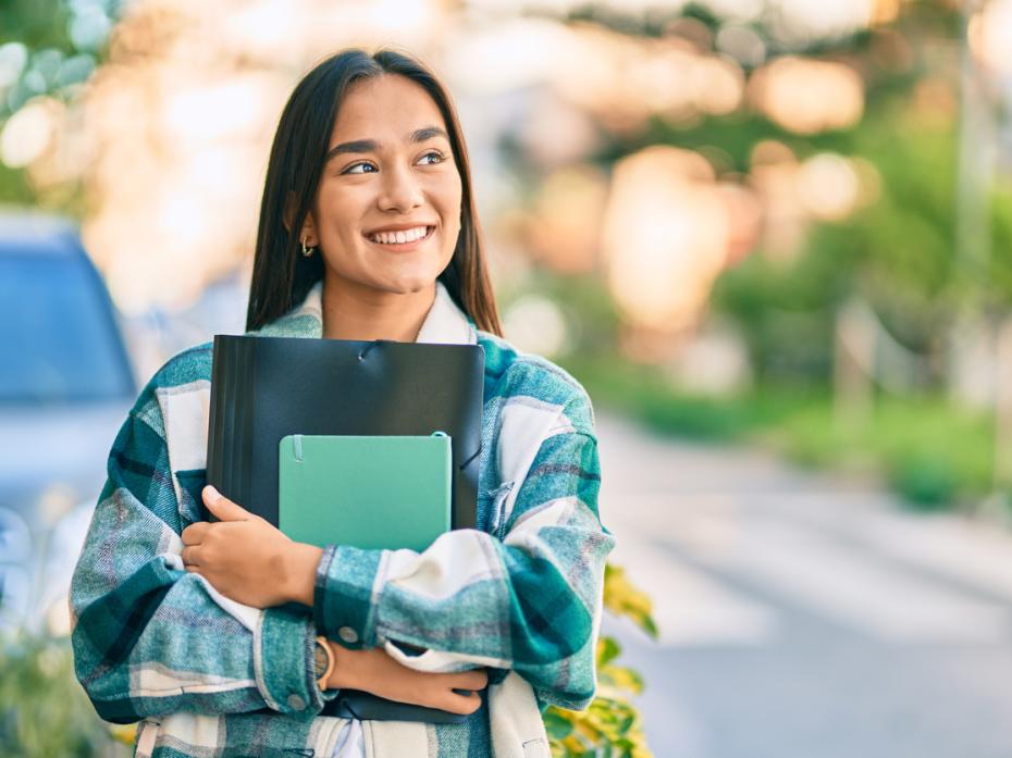 A university student standing outside a campus building 