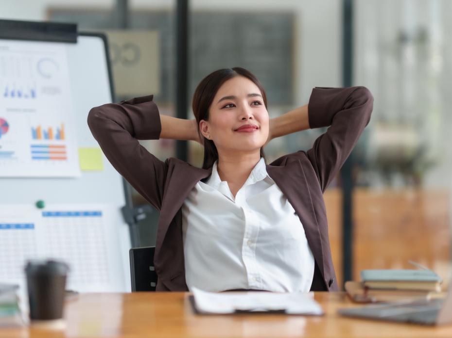 A woman looking relaxed sitting at her desk