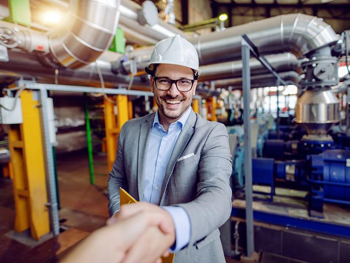 Man in hard hat shaking hands