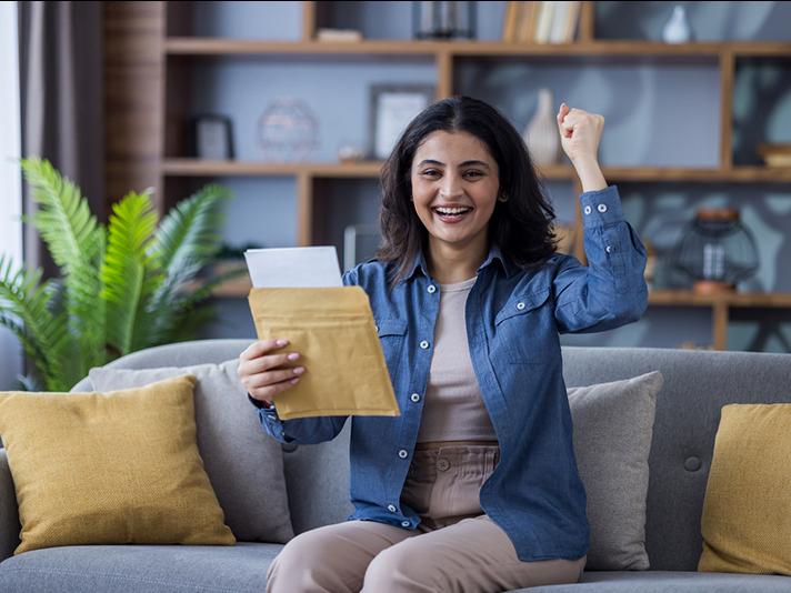 Young happy Indian woman on a couch