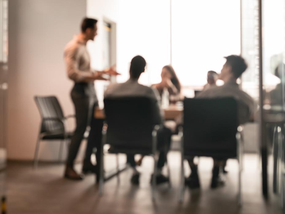 employees sitting at a boardroom table