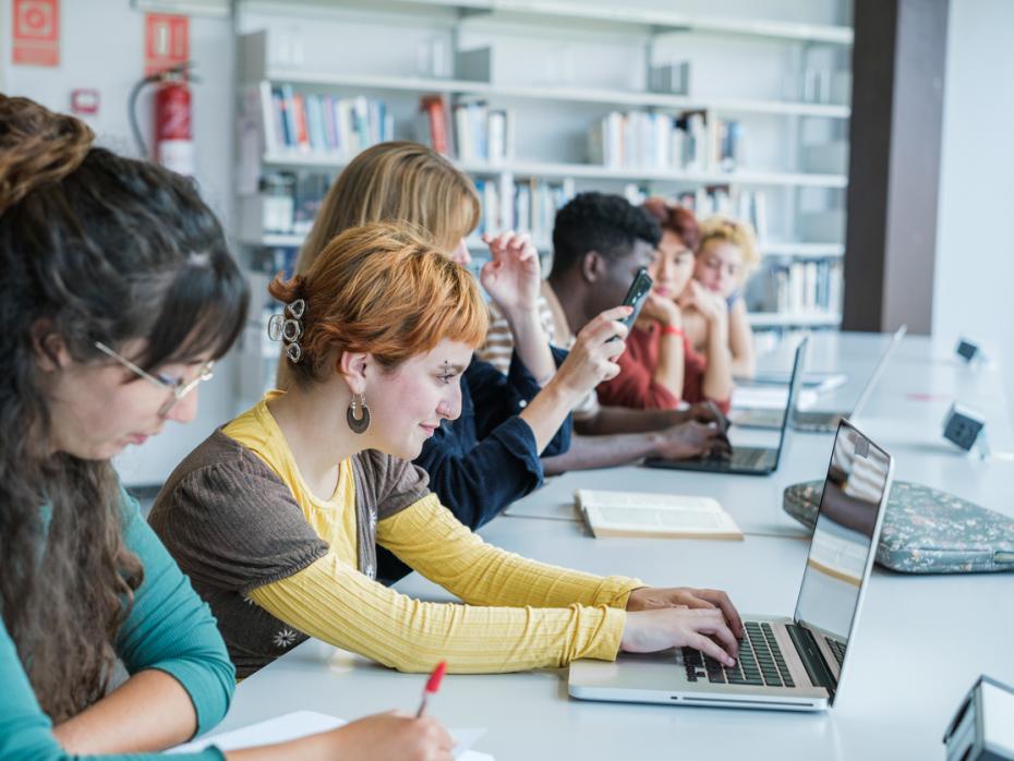 Students on laptops in a classroom