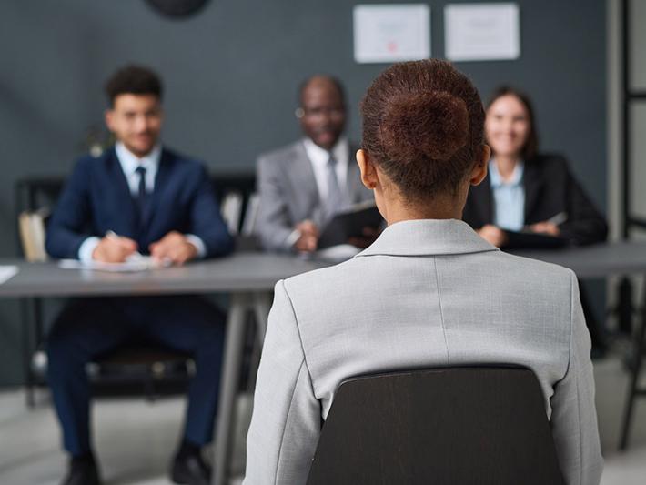 Young black woman before panel during job interview