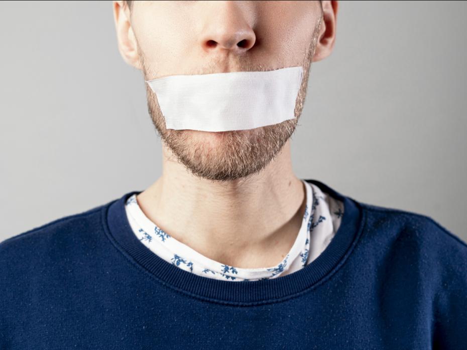 A man with tape on his mouth