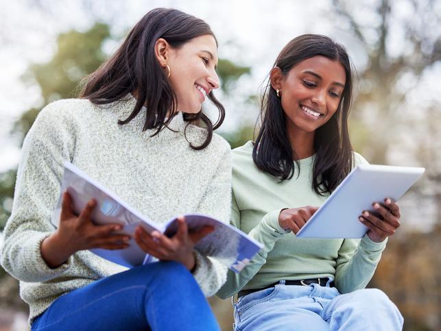 Two female students study together