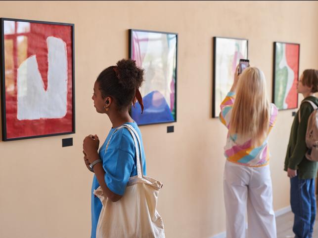 Students observe art in a gallery