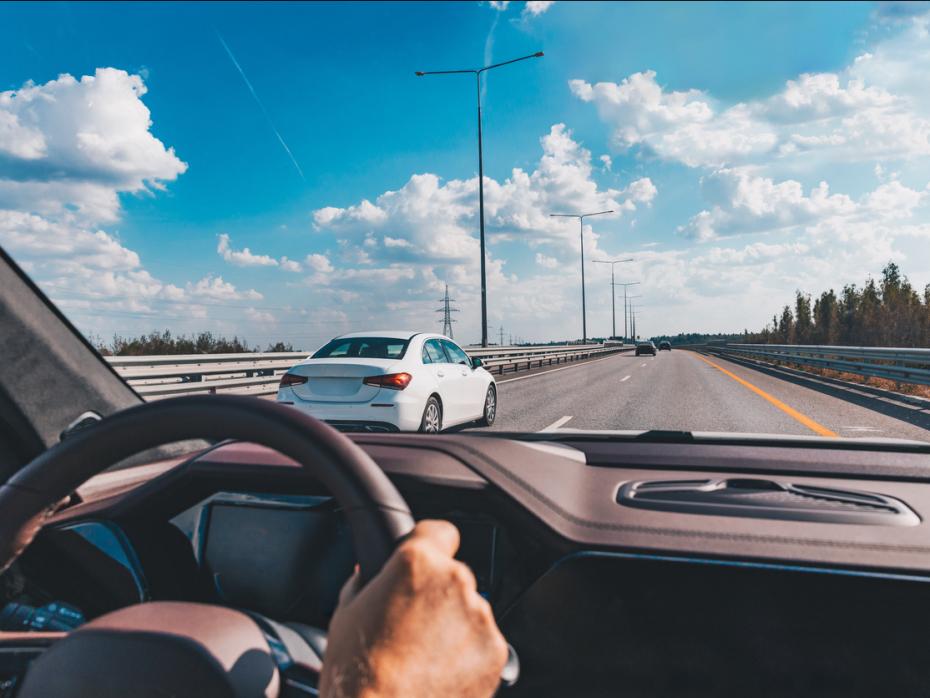 An unseen driver at the wheel of a car