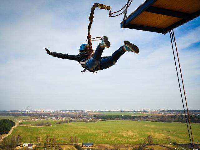 A bungee jumper leaps from a platform