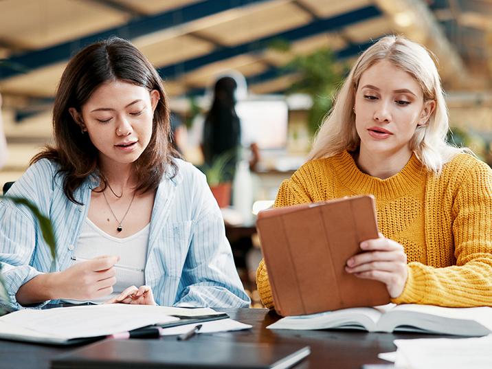 Female college students working together in class