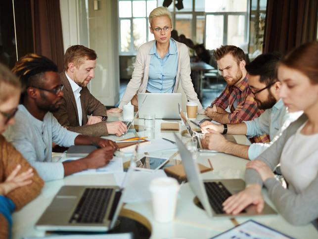 A meeting takes place around a long table