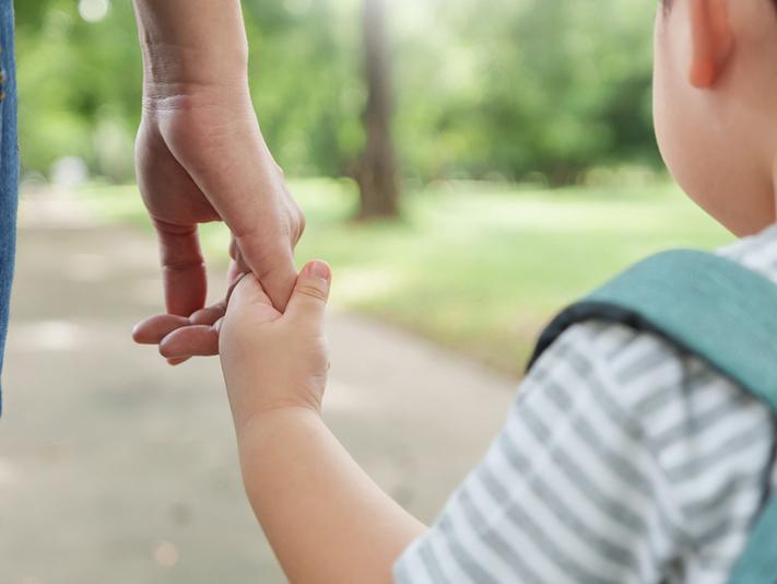 Mother holding small child’s hand