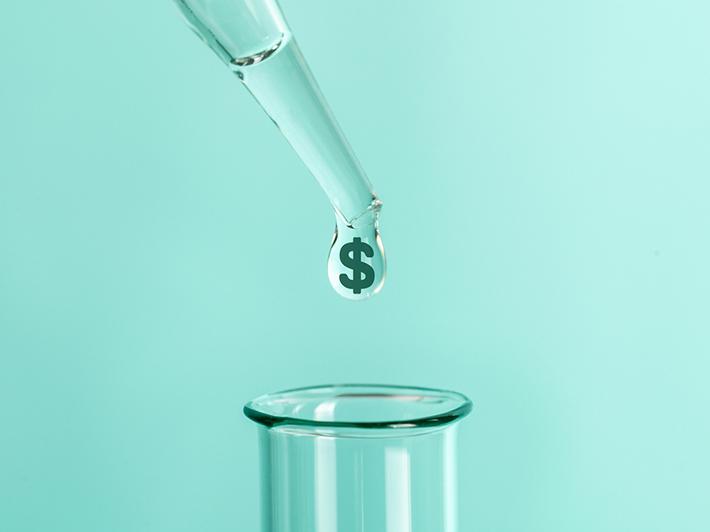 Liquid with dollar sign dropping into test tube, research funding