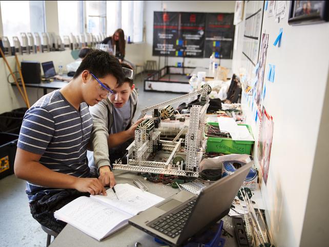 Two engineering students work together on a project