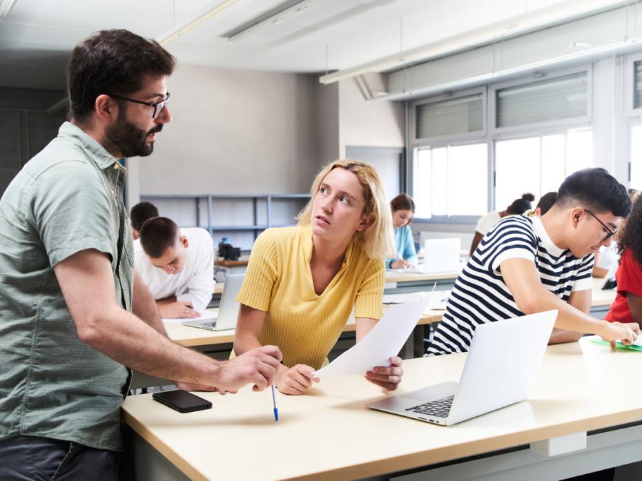 A student speaking to a teacher in class