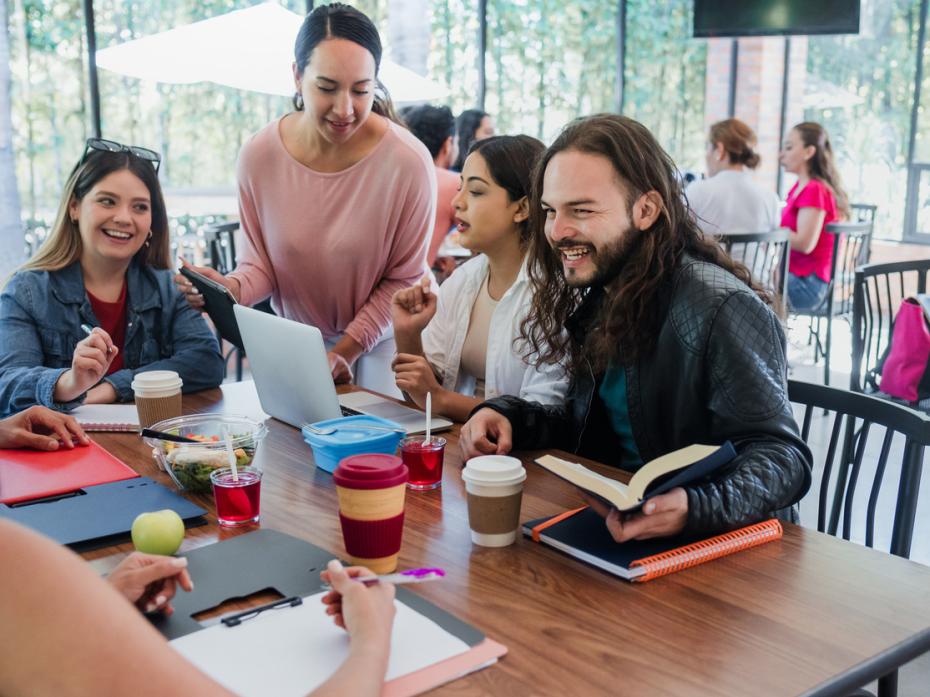 Students chatting together at a table in class