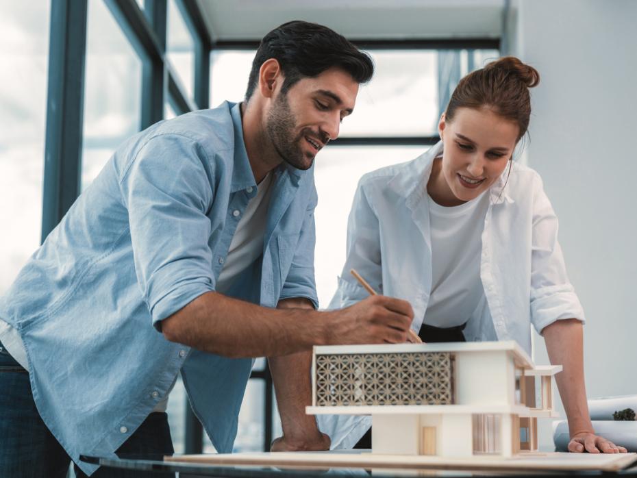 Two designers making a model of a building