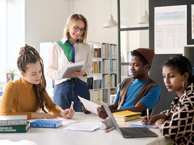 An educator talks to international students