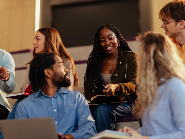 Students discuss with their lecturer