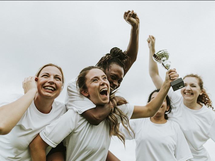 Women footballers celebrating victory