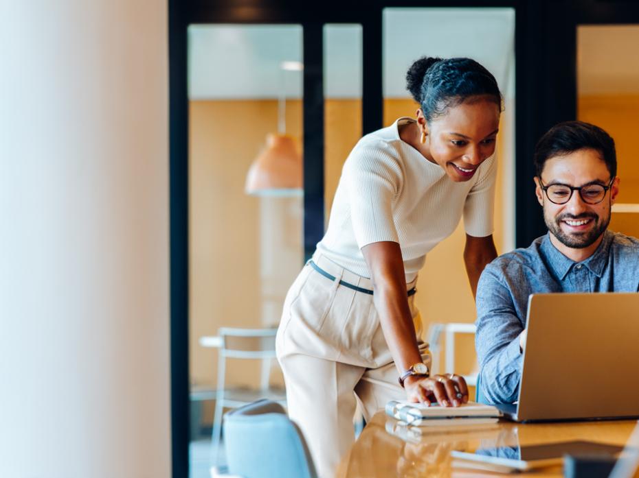 Two colleagues working at a laptop