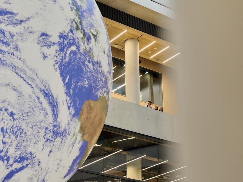 A large globe statue in a campus building