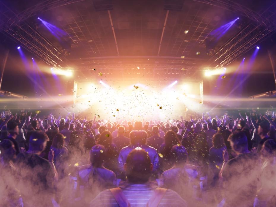 A concert crowd and strobe-lit stage
