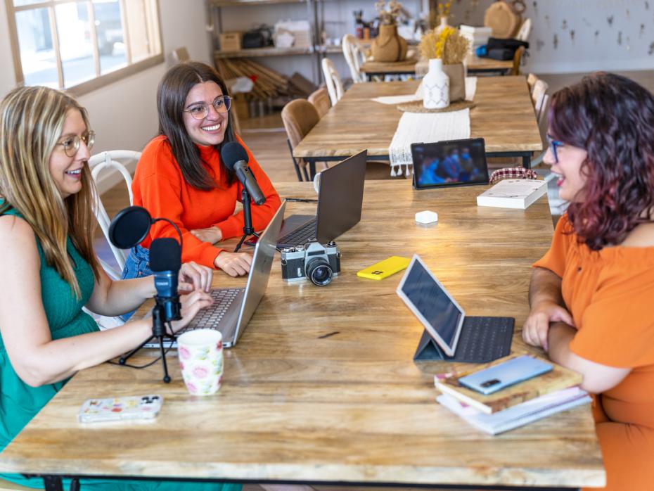 Students sitting at a table with their laptops