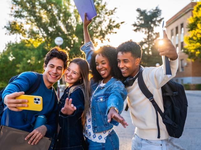 Students pose for a group selfie
