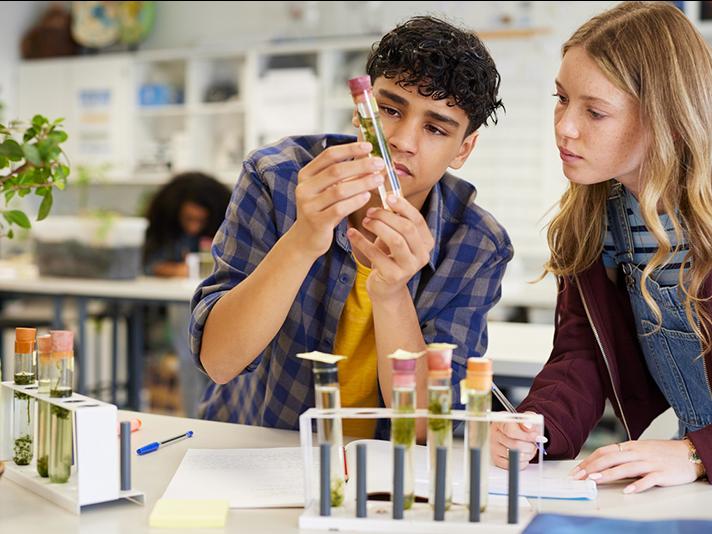 Young male and female high school students in a chemistry lab