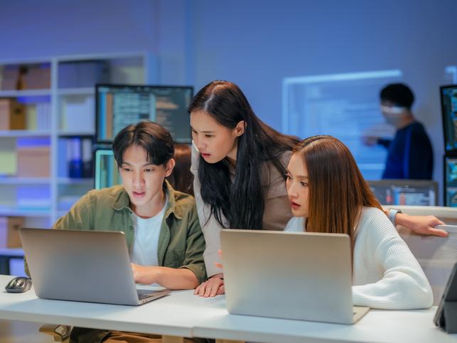 Students work together over a laptop