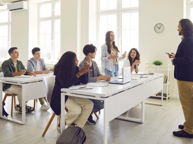 A student stands up to talk in the classroom