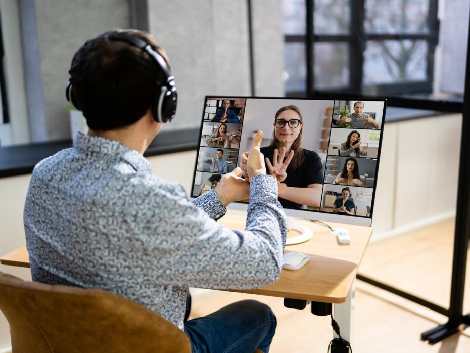A deaf student on a video call with other participants using sign language