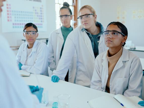 Students in a lab listen to the instructor