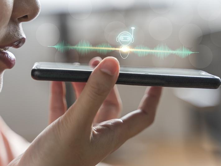 Woman talking into smartphone, AI as student support