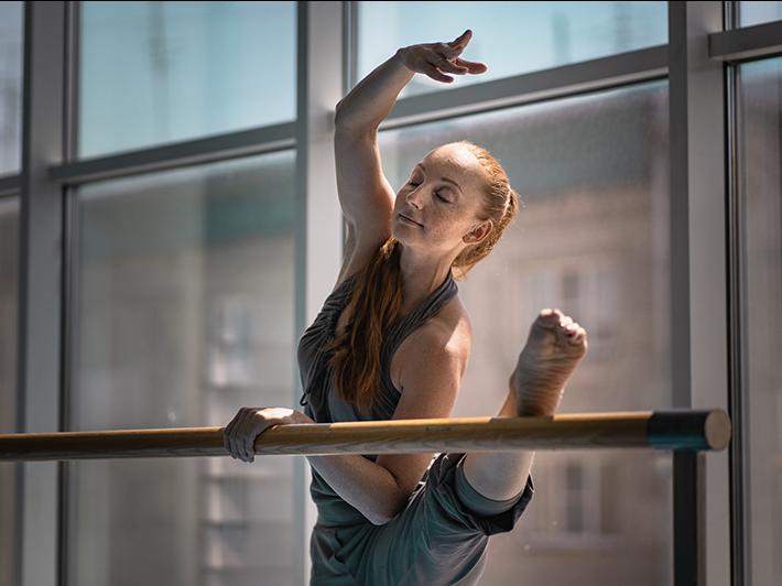 ballet dancer stretching at barre