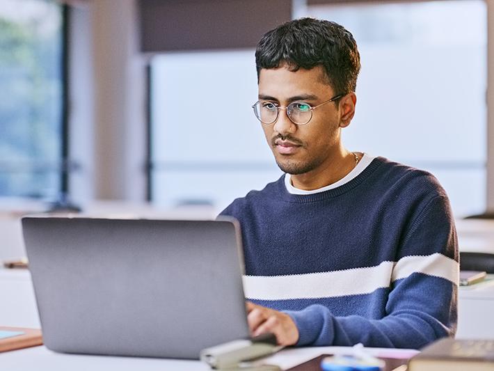 Asian man working at laptop