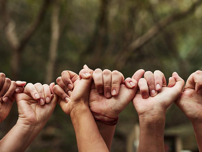 Hands linked in a line
