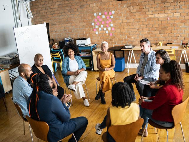 Research participants sit together in a circle
