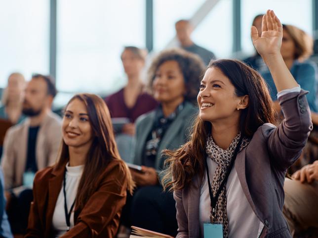 Students raising their hands in class