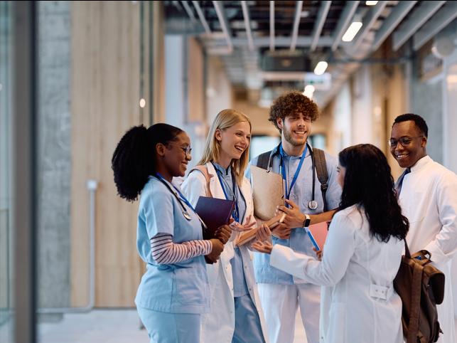 Medical students talk in a university corridor