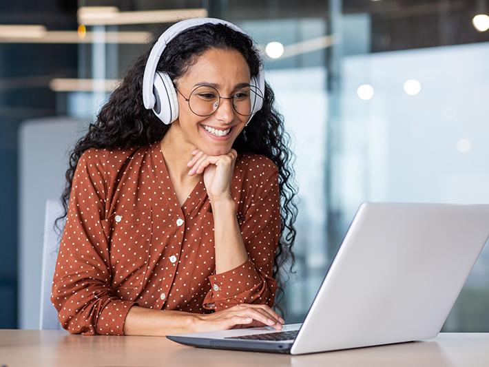 Female student smiling at laptop