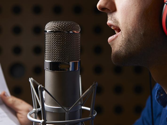 Man recording a voiceover in studio